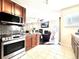Well-equipped kitchen with stainless steel appliances, granite countertops, and a seamless view into the adjacent living room at 12830 Jasmine St # A, Thornton, CO 80602