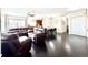 Spacious living room with hardwood floors, comfortable seating, and a view into the dining area and kitchen at 12830 Jasmine St # A, Thornton, CO 80602