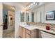 Bathroom with sink, large mirror, medicine cabinet and glass enclosed shower at 460 S Marion Pkwy # 102, Denver, CO 80209