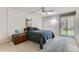 Bedroom with a comfy bed, slider glass door, brick walls and neutral carpet at 460 S Marion Pkwy # 102, Denver, CO 80209