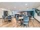Well-lit dining room area with modern tables and chairs at 460 S Marion Pkwy # 102, Denver, CO 80209