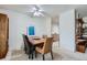 Bright dining room with modern table, ceiling fan and exposed brick wall at 460 S Marion Pkwy # 102, Denver, CO 80209