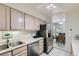 Functional kitchen with stainless steel appliances, tile floors, and bright breakfast nook at 460 S Marion Pkwy # 102, Denver, CO 80209