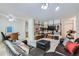 Open concept living room and dining room with comfortable seating and updated ceiling fan at 460 S Marion Pkwy # 102, Denver, CO 80209