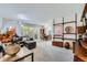 Spacious living room featuring neutral carpet, a large sectional sofa, and dining area at 460 S Marion Pkwy # 102, Denver, CO 80209