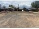 Large gravel backyard with a chain link fence, shed, and detached garage at 6441 Niagara St, Commerce City, CO 80022