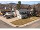Two-story home with spacious driveway, RV parking, and mountain views in the background at 4391 S Tabor Ct, Morrison, CO 80465