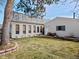 Backyard with a patio, a well-manicured lawn, mature trees, and house exterior at 4391 S Tabor Ct, Morrison, CO 80465