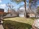 Backyard showcasing a well-maintained lawn, a storage shed, and a wooden privacy fence at 4391 S Tabor Ct, Morrison, CO 80465