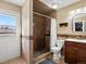 Bathroom featuring a tiled walk-in shower and modern vanity at 4391 S Tabor Ct, Morrison, CO 80465