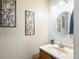 Cozy half bathroom with a modern vanity and decorative wall art at 4391 S Tabor Ct, Morrison, CO 80465