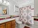 Well-lit bathroom with a sink, toilet, and decorative shower curtain at 4391 S Tabor Ct, Morrison, CO 80465
