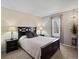 Inviting bedroom featuring a dark wood bed frame, bedside tables with lamps, and neutral décor at 4391 S Tabor Ct, Morrison, CO 80465