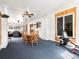 Open floor plan showcasing a dining room with a wooden table and exercise equipment at 4391 S Tabor Ct, Morrison, CO 80465
