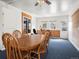 Large dining room with an oval wooden table, chairs, and natural light at 4391 S Tabor Ct, Morrison, CO 80465