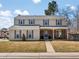 Two-story home with blue shutters, a welcoming front porch, and well-maintained lawn at 4391 S Tabor Ct, Morrison, CO 80465