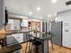 Open kitchen featuring modern appliances, granite counters, and a kitchen island with seating at 4391 S Tabor Ct, Morrison, CO 80465
