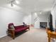 Cozy living room with a futon, wooden furniture, and neutral carpet at 4391 S Tabor Ct, Morrison, CO 80465