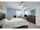 Comfortable bedroom with light blue walls, ceiling fan, and a window with lots of light at 15800 E 121St Ave # 4G, Brighton, CO 80603