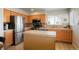 Well-lit kitchen with stainless steel appliances, island, and ample counter space at 15800 E 121St Ave # 4G, Brighton, CO 80603