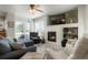 Sunlit living room with fireplace, modern furnishings and an easy transition to the outdoor space via sliding glass doors at 15800 E 121St Ave # 4G, Brighton, CO 80603