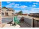 Private fenced-in patio offering a peaceful outdoor space with a green chair and neighborhood views at 15800 E 121St Ave # 4G, Brighton, CO 80603
