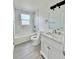 Updated bathroom featuring marble tile, modern vanity, and shower over tub at 1100 N Hanover St, Aurora, CO 80010