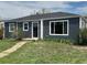 Charming single story home with new gray horizontal siding, white trim, and a well-manicured front yard at 1100 N Hanover St, Aurora, CO 80010