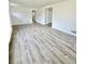 Spacious living room with white walls and wood-look flooring, creating a bright and modern space at 1100 N Hanover St, Aurora, CO 80010