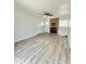 Living room featuring new gray flooring and a brick fireplace, creating a cozy and inviting atmosphere at 1100 N Hanover St, Aurora, CO 80010