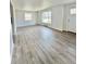 Bright living room with wood-look flooring and large windows providing ample natural light at 1100 N Hanover St, Aurora, CO 80010