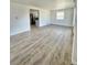 Bright living room with wood-look flooring, open to the kitchen with stainless steel appliances at 1100 N Hanover St, Aurora, CO 80010