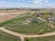 Expansive aerial view of the property and surrounding land, showing a home and rural landscape under a blue sky at 3559 Meadow Ln, Brighton, CO 80603