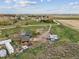An elevated perspective shows the home, outbuildings and property nestled within the scenic countryside at 3559 Meadow Ln, Brighton, CO 80603