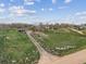 An aerial perspective showcases the property, buildings, and surrounding acreage with clear blue skies above at 3559 Meadow Ln, Brighton, CO 80603