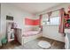Charming bedroom with pink accents, a built-in bed, and ample natural light at 3559 Meadow Ln, Brighton, CO 80603