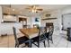 Dining area adjacent to the kitchen and fireplace, featuring a wooden table and ample seating at 3559 Meadow Ln, Brighton, CO 80603