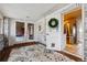 Inviting entryway boasts brick walls, a patterned rug, and seamless access to the kitchen and living spaces at 3559 Meadow Ln, Brighton, CO 80603