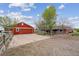 Spacious property includes a large garage, home and garden space, set against a backdrop of lush greenery at 3559 Meadow Ln, Brighton, CO 80603