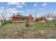 Exterior view of brick home with green roof, grassy yard and a shed in the background at 3559 Meadow Ln, Brighton, CO 80603