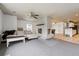 Open concept living room with a striking white brick fireplace and views into the dining area at 3559 Meadow Ln, Brighton, CO 80603