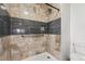 Close up of remodeled shower with marble tiling and sleek fixtures at 3559 Meadow Ln, Brighton, CO 80603