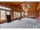 Spacious sunroom with brick walls, wood ceiling, lots of natural light, and blue patterned carpet at 3559 Meadow Ln, Brighton, CO 80603