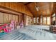 Sunroom featuring brick walls, wood ceilings, light blue carpet, and backyard access at 3559 Meadow Ln, Brighton, CO 80603