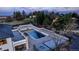 Large backyard featuring a pool, hot tub, patio, and outdoor seating areas, perfect for entertaining at 15902 W 64Th Ave, Arvada, CO 80007