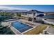 Aerial view showcasing the home's pool, hot tub, patio, and serene mountain backdrop at 15902 W 64Th Ave, Arvada, CO 80007