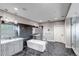 Large bathroom with soaking tub, glass shower, dual sinks, and sleek modern finishes at 15902 W 64Th Ave, Arvada, CO 80007