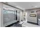 Bright bathroom featuring large walk-in shower, fireplace, and modern fixtures at 15902 W 64Th Ave, Arvada, CO 80007