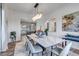 Bright dining room featuring modern lighting, abstract art, neutral color palette and light hardwood floors at 15902 W 64Th Ave, Arvada, CO 80007