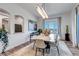 Bright dining room featuring modern lighting, abstract art, neutral color palette and light hardwood floors at 15902 W 64Th Ave, Arvada, CO 80007